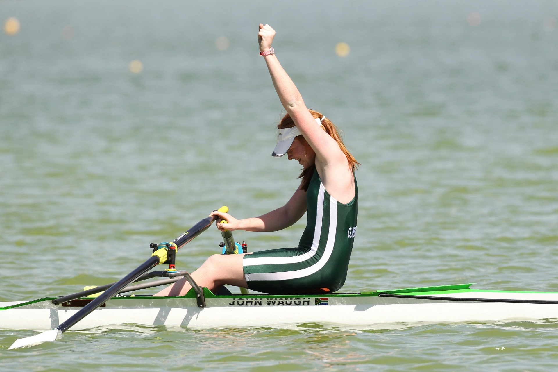 Single sculler celebrating after a rowing performance